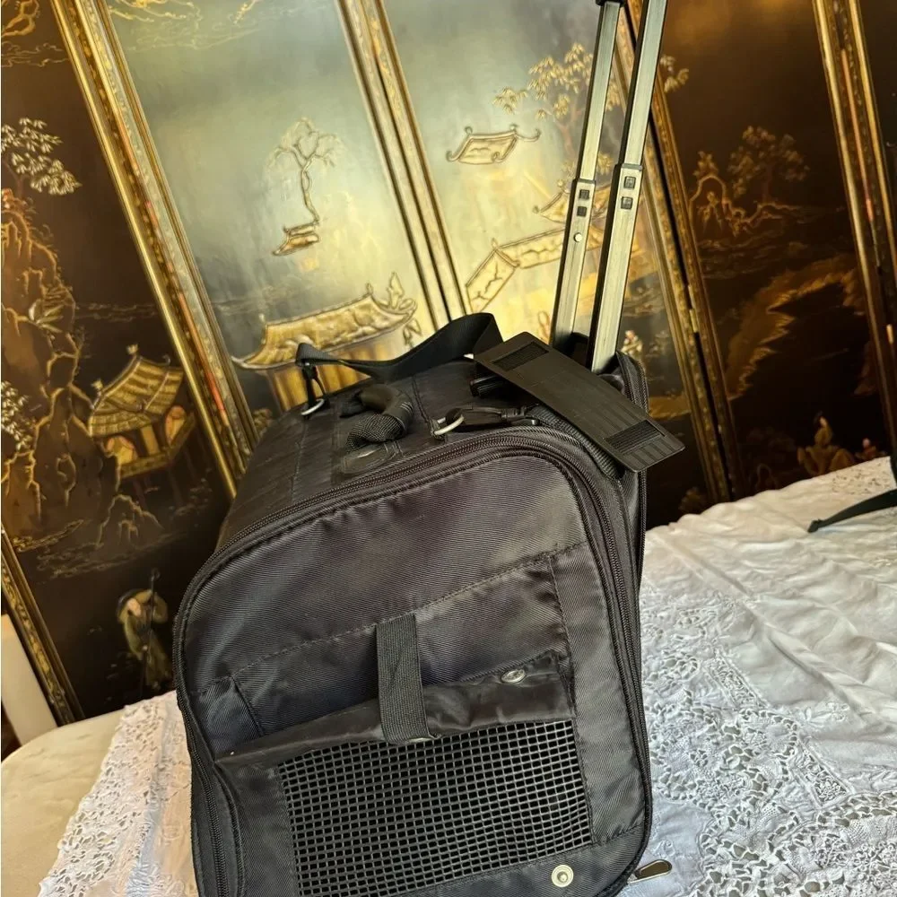 Eddie Bauer black expandable handle, rolling small pet carrier. ￼